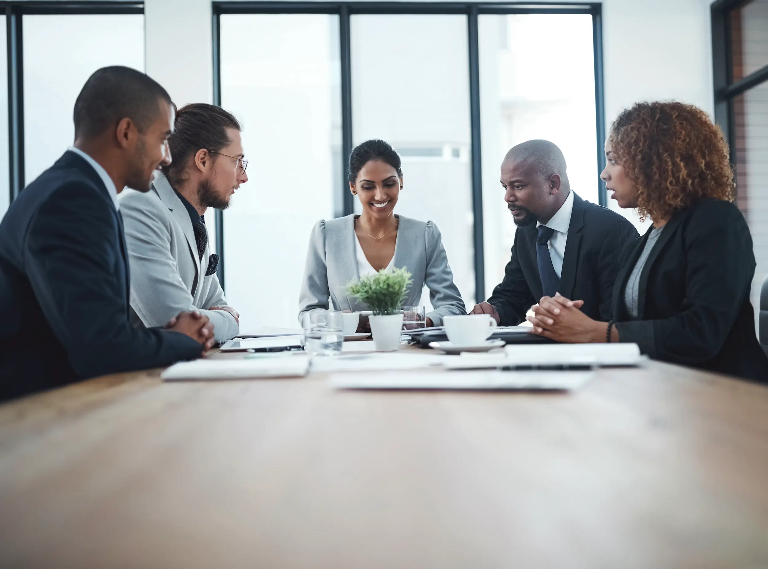 business professionals meeting at a table in offic 2026