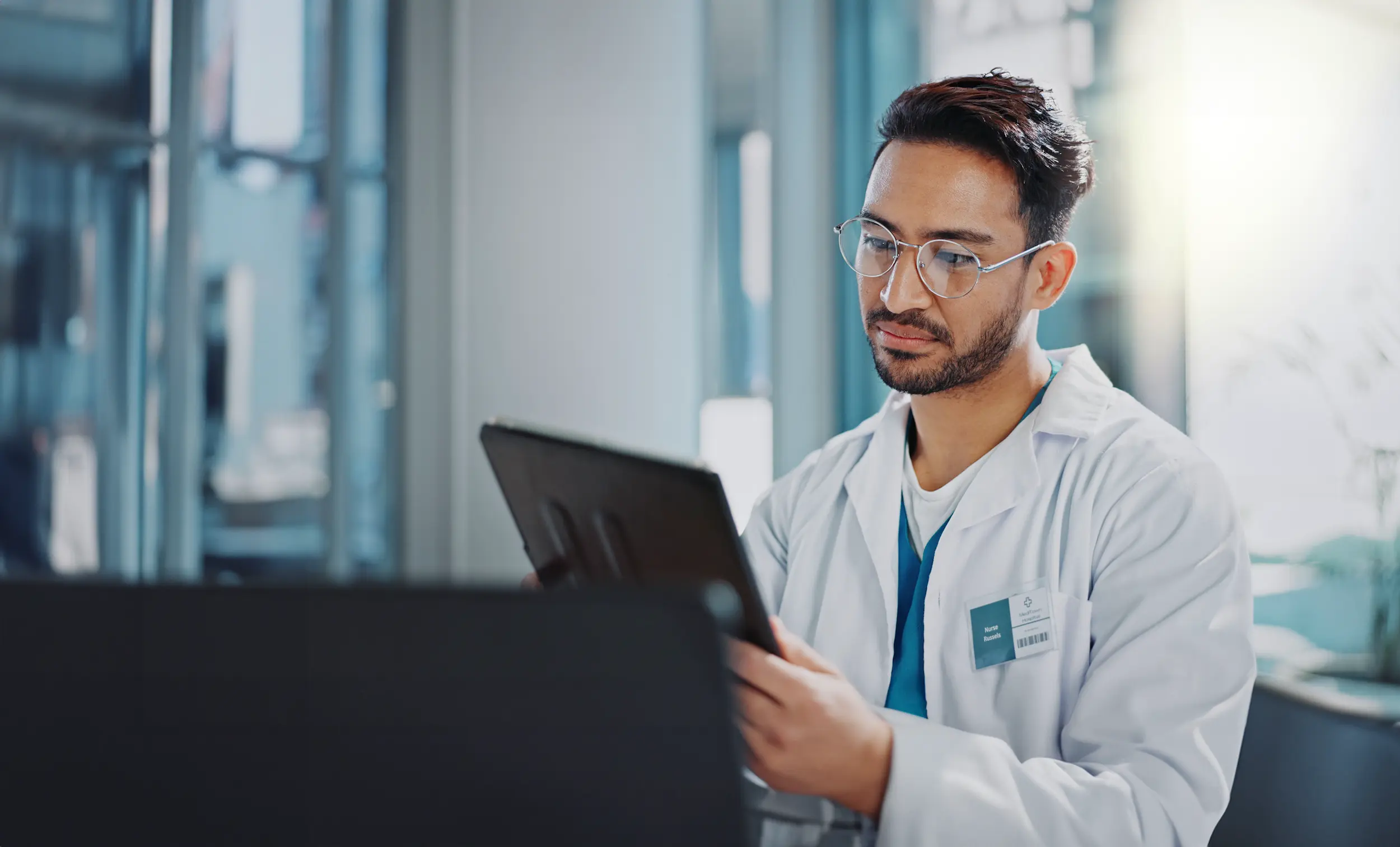doctor man and tablet with results consultation 2026