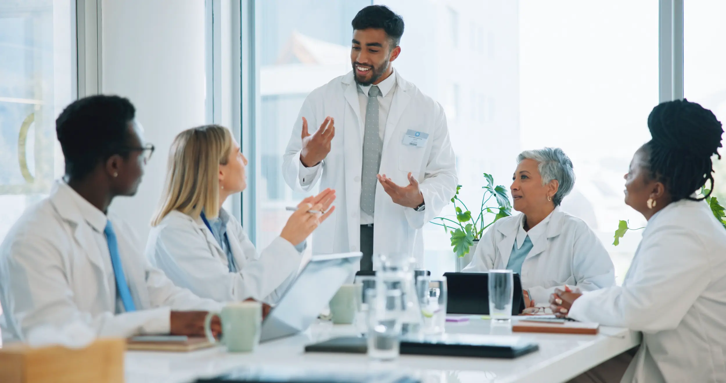 man doctor and team in meeting for healthcare pl 2026